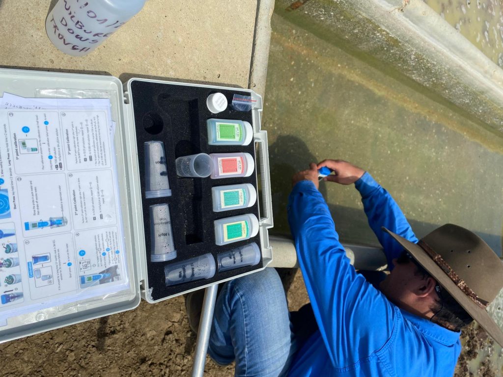 Our team in the field, conducting a water test for a customer. Livestock nutrition testing.
